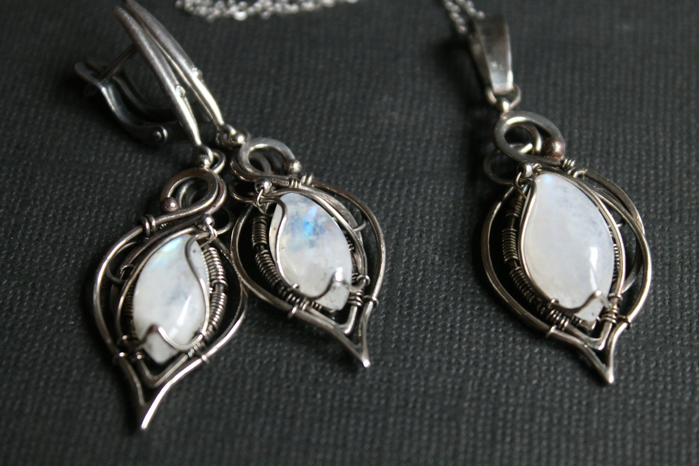 Handmade silver wire-wrapped jewelry set with moonstone accents.